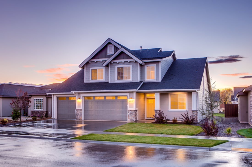 A beautiful suburban home with newly serviced dual bay doors by a professional garage door repair Austin TX company at sunset.